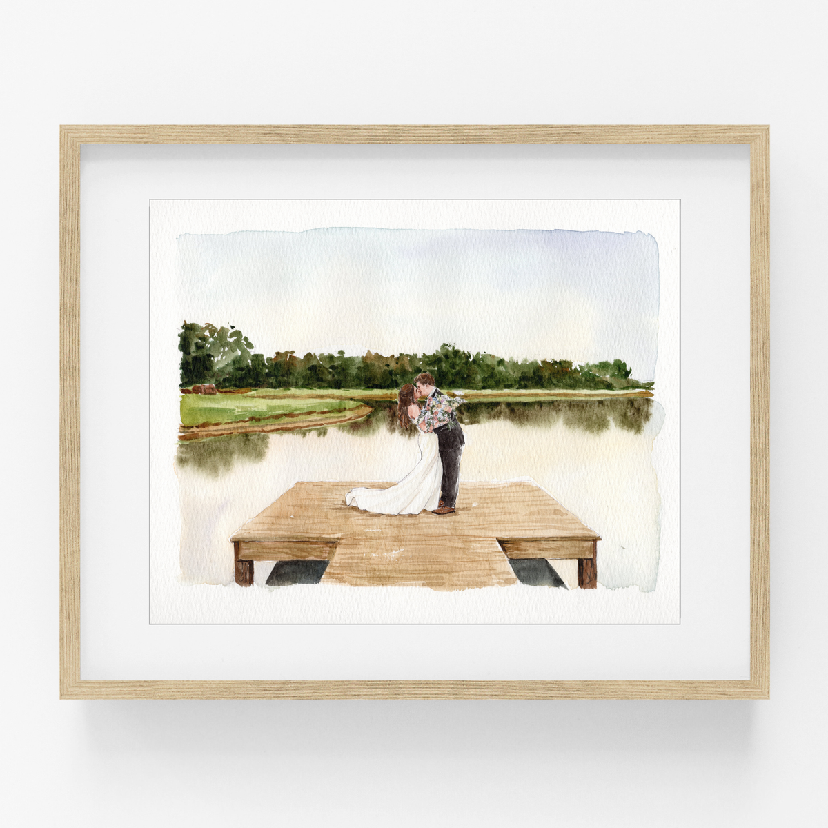 Framed watercolor portrait of a wedding couple standing on a wooden dock beside a calm lake.