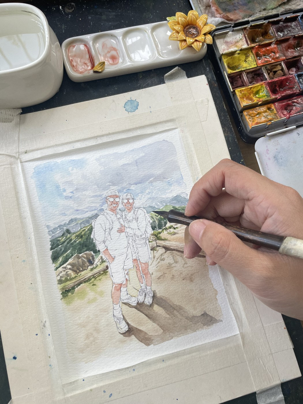 Hand-painting a custom couple watercolor hiking portrait in progress