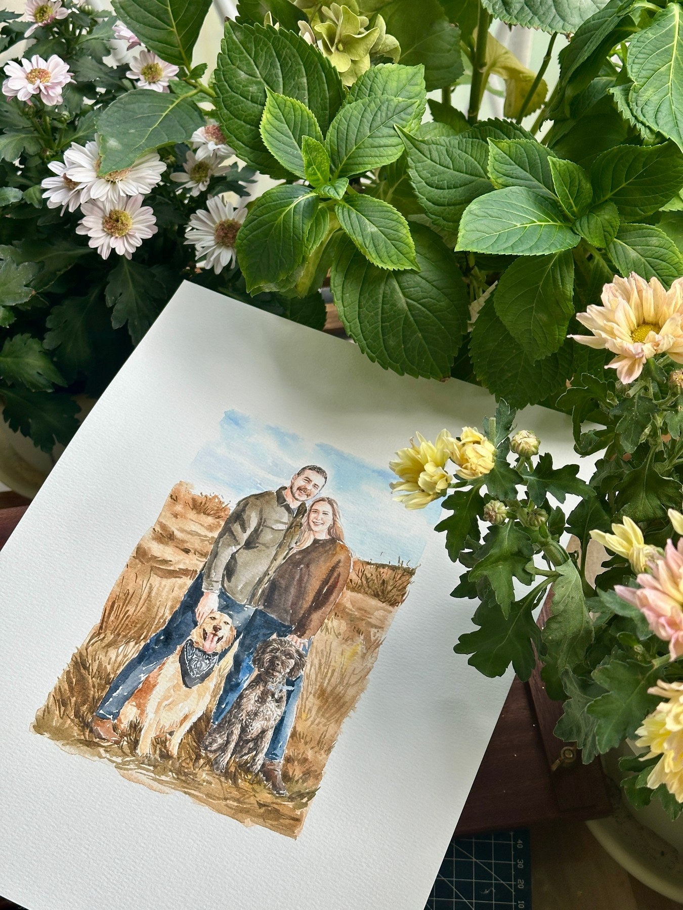 Couple with two dogs in a scenic watercolor family portrait