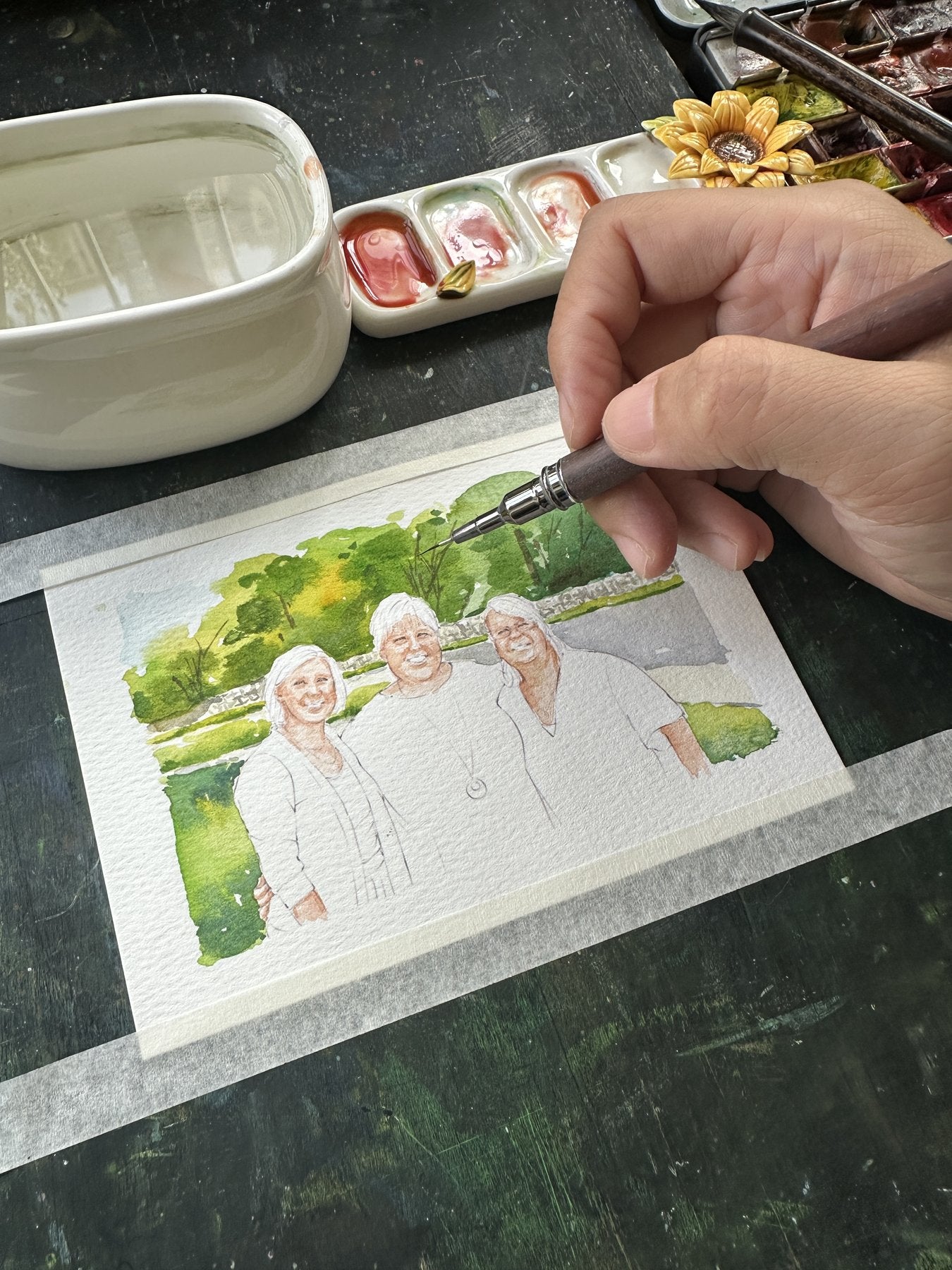 A family portrait of three women being painted by hand