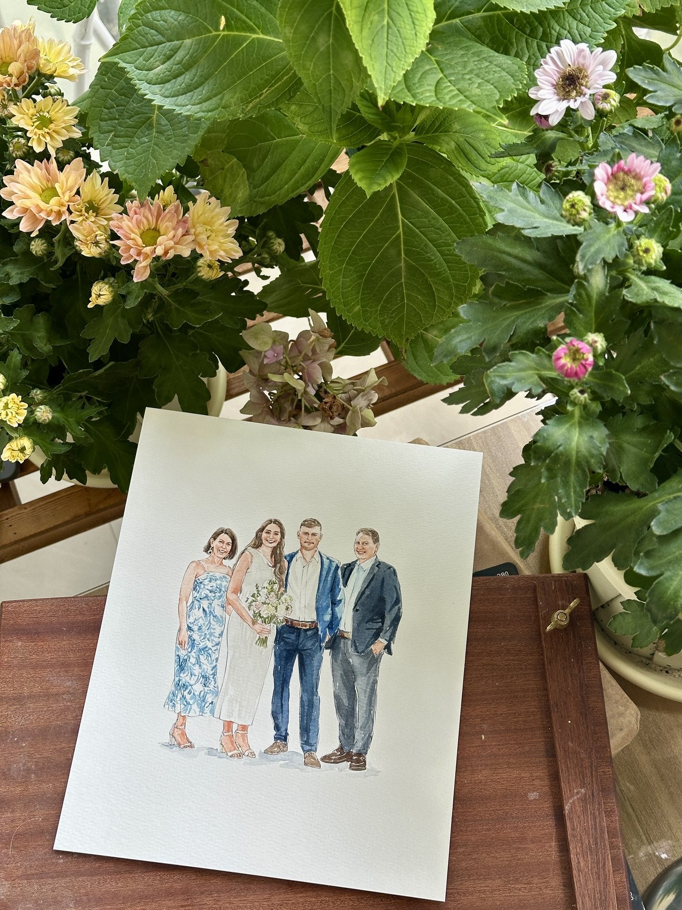 Finished hand-painted watercolor portrait of a family at a wedding