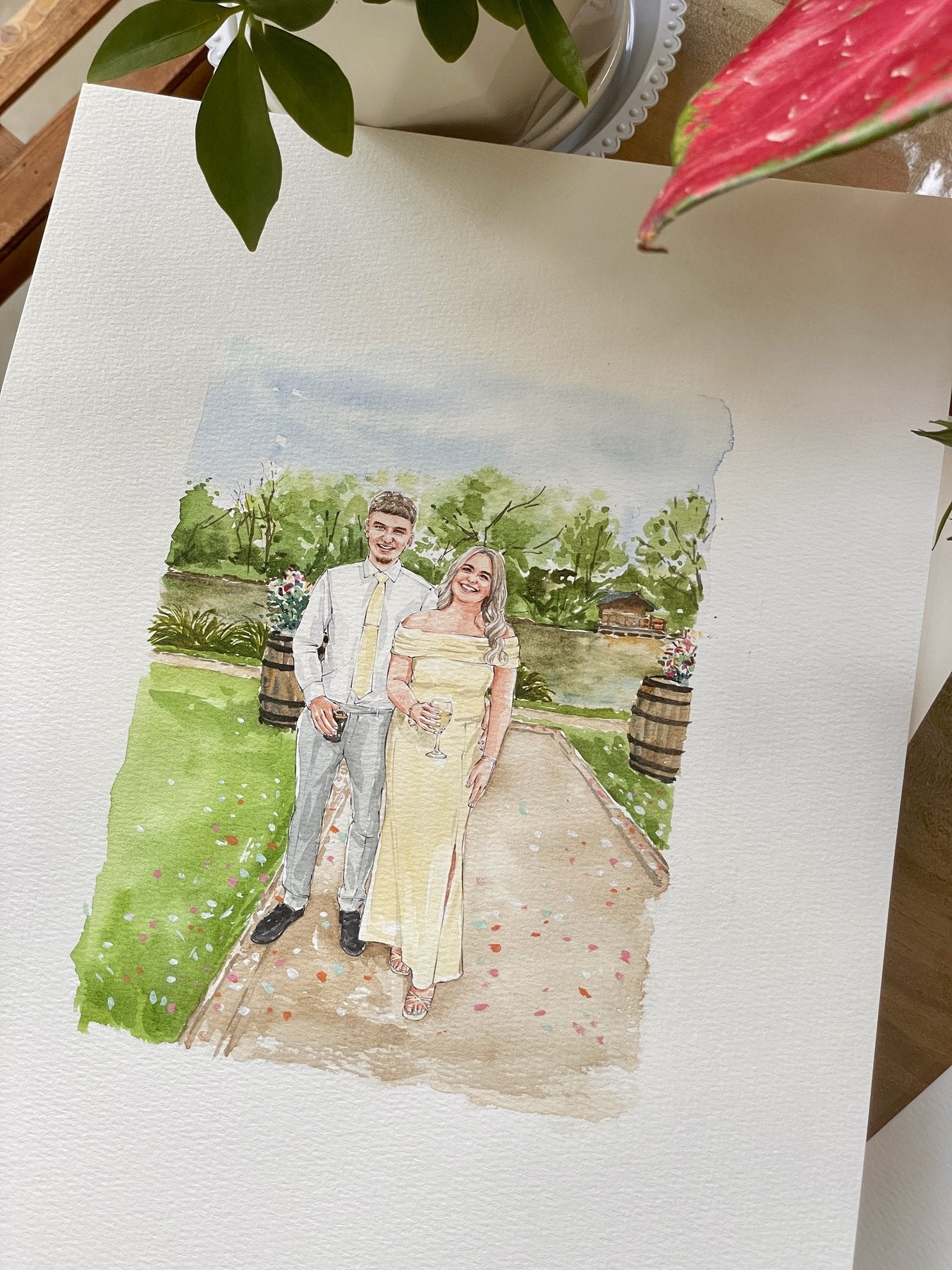 Finished watercolor portrait of a couple at a garden celebration