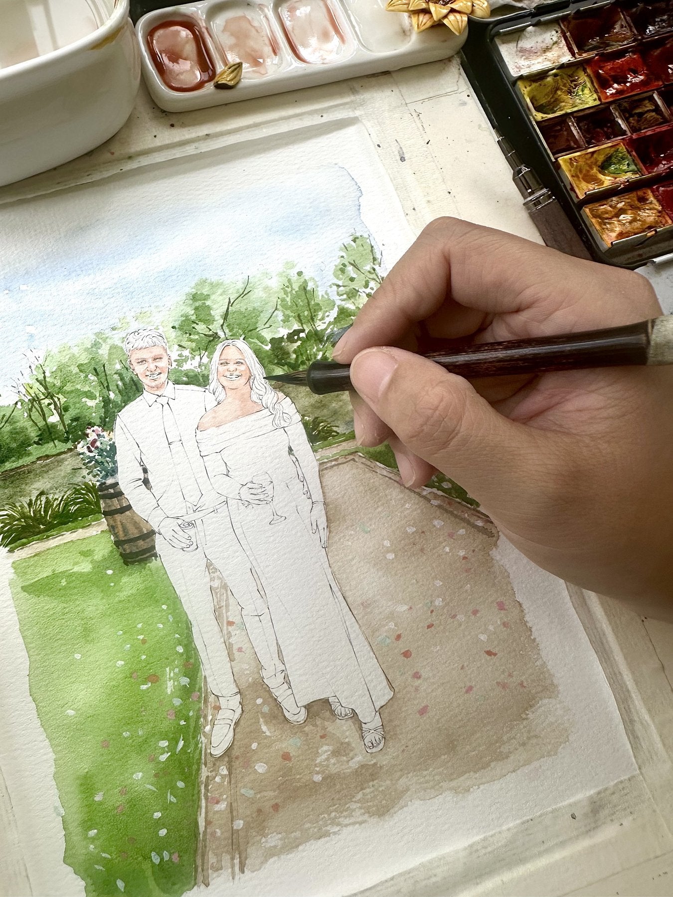A formal couple portrait being painted in watercolor