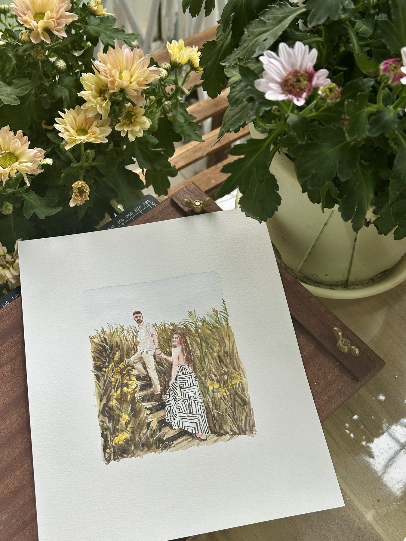 Finished hand-painted watercolor portrait of a couple in a meadow