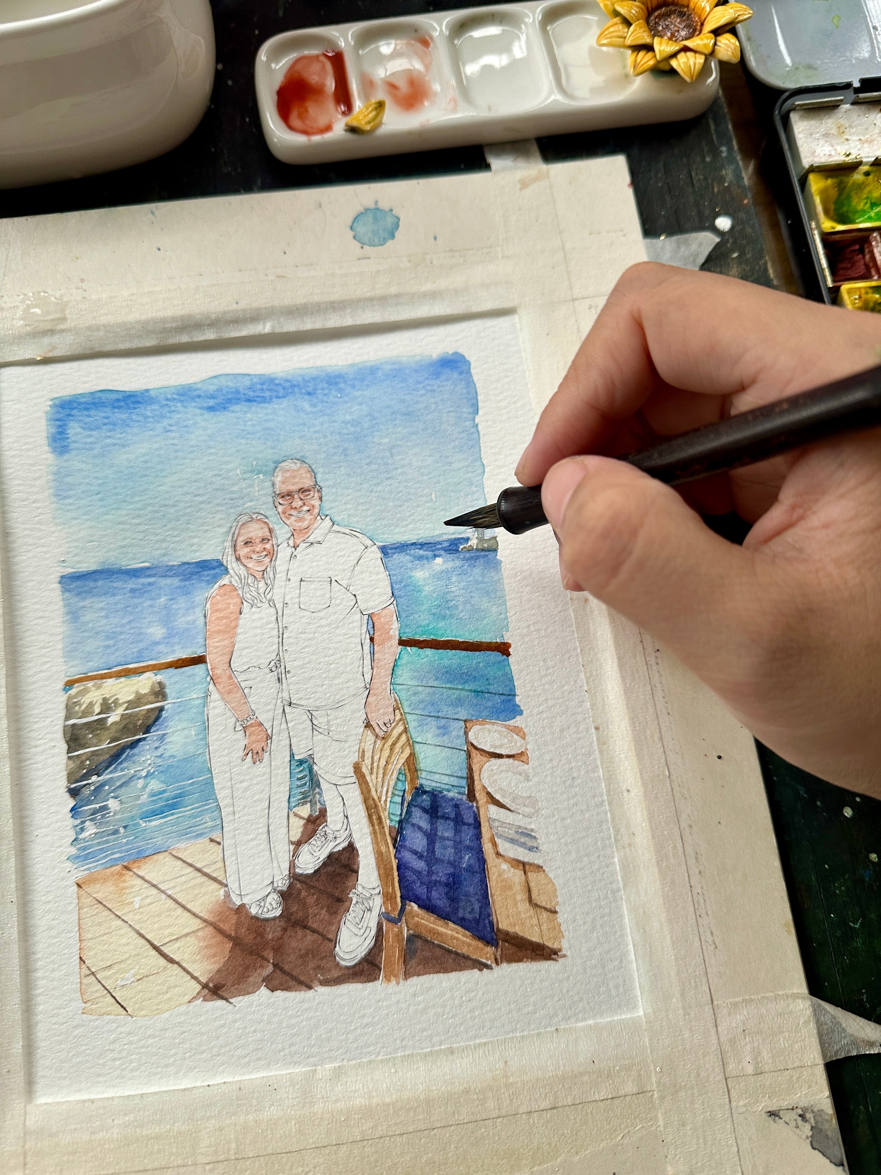 Ocean journey couple portrait being painted by hand