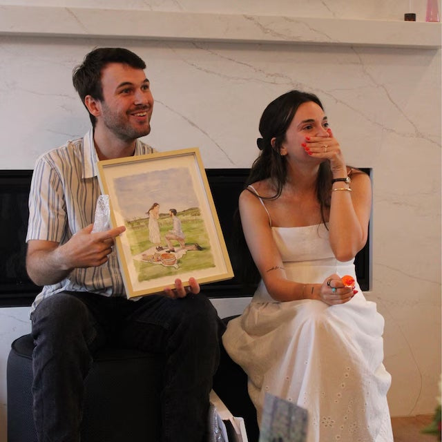 Couple holding a custom watercolor portrait